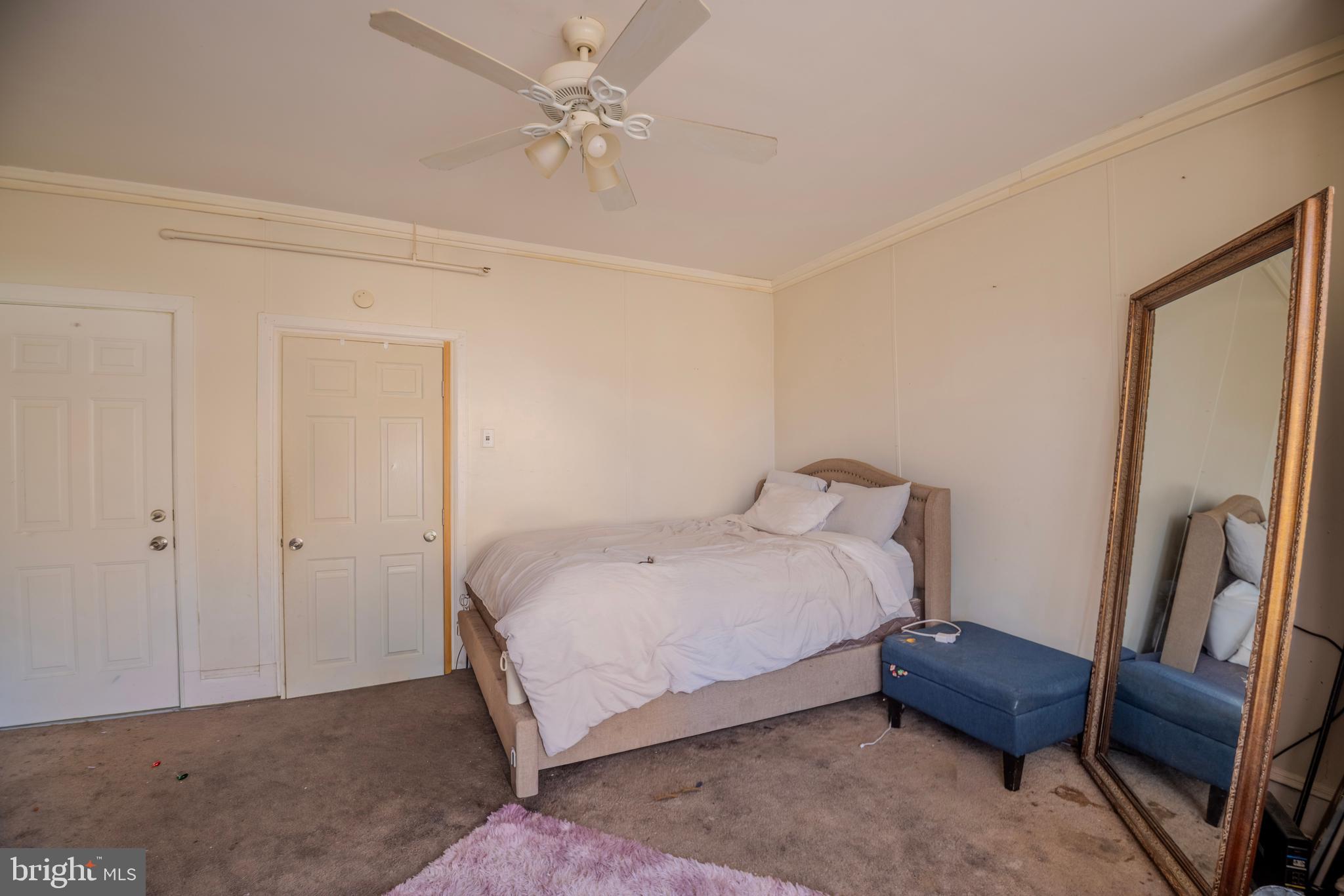 323 West 7th Street Chester, PA 19013 - Photo 34 of 39 a bedroom with a bed and a chandelier