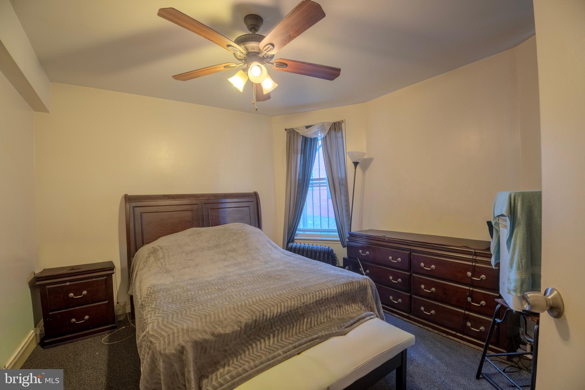 323 West 7th Street Chester, PA 19013 - Photo 8 of 39 a bedroom with a bed and a chandelier
