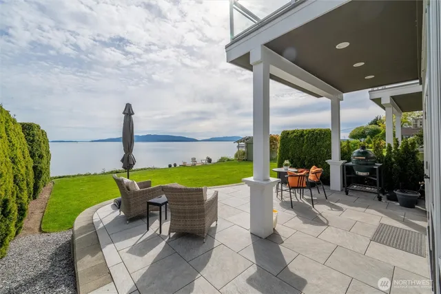 a view of a patio with a table chairs and a backyard