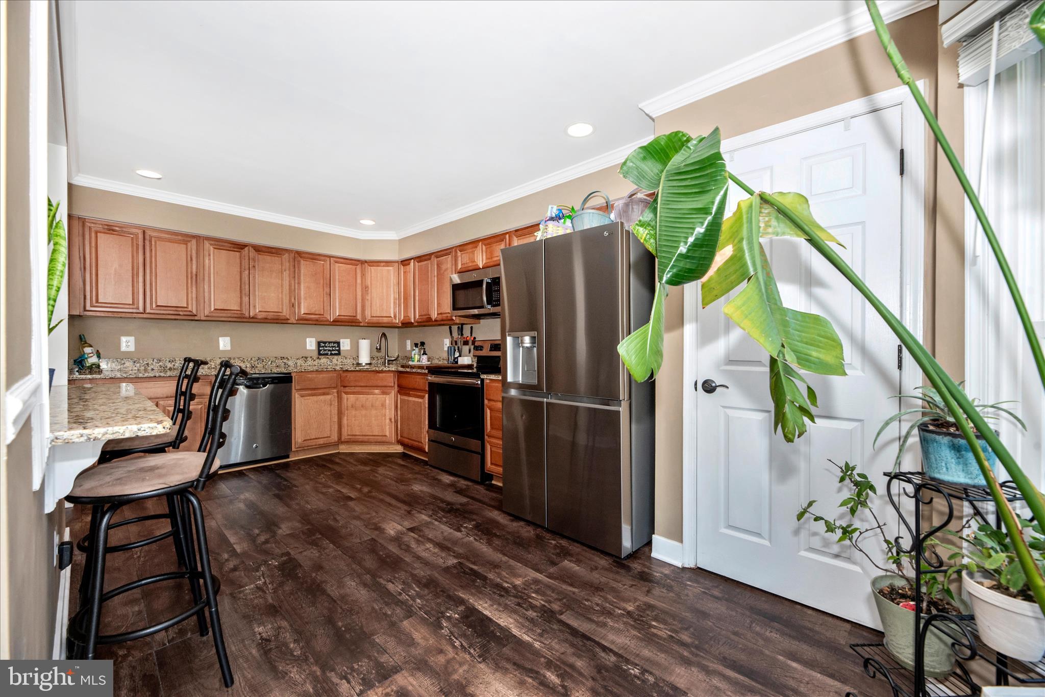 6630 Commodore Court New Market, MD 21774 - Photo 16 of 68 a kitchen with stainless steel appliances granite countertop a refrigerator a stove and a wooden floor
