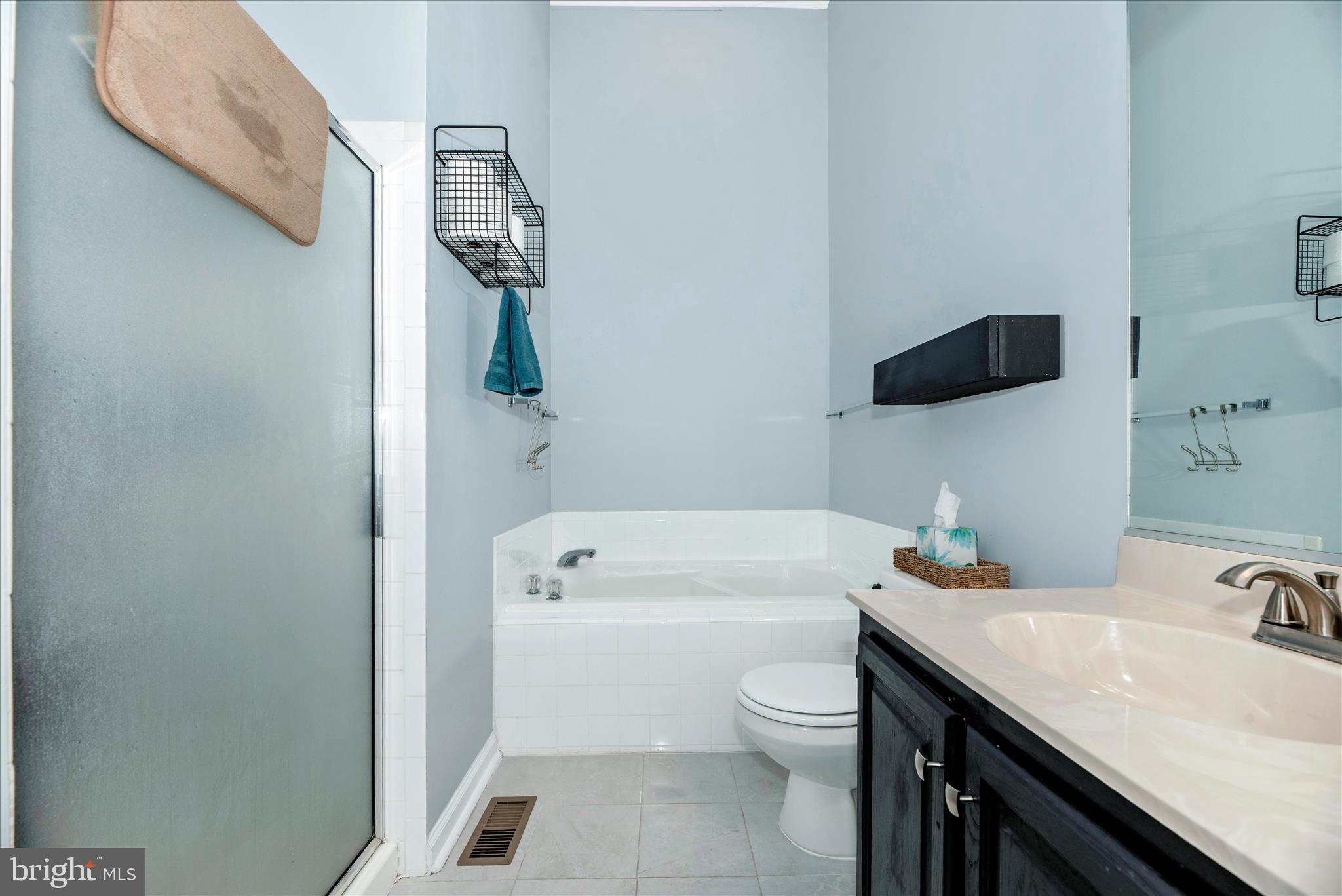 6630 Commodore Court New Market, MD 21774 - Photo 23 of 68 a bathroom with a granite countertop sink a toilet and a mirror