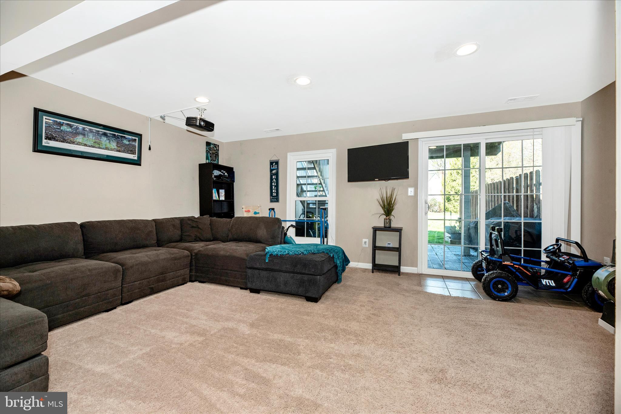 6630 Commodore Court New Market, MD 21774 - Photo 29 of 68 a living room with furniture a flat screen tv and a large window