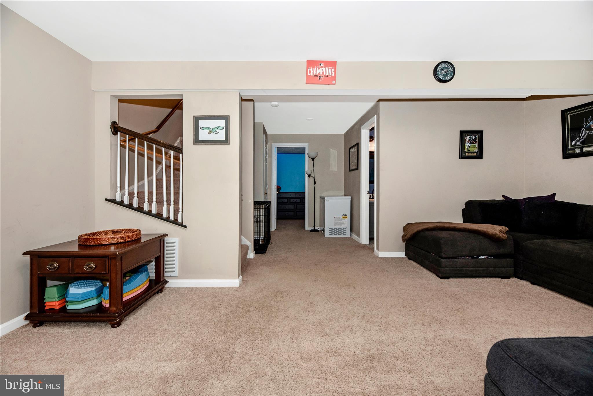 6630 Commodore Court New Market, MD 21774 - Photo 30 of 68 a living room with furniture a flat screen tv and a refrigerator