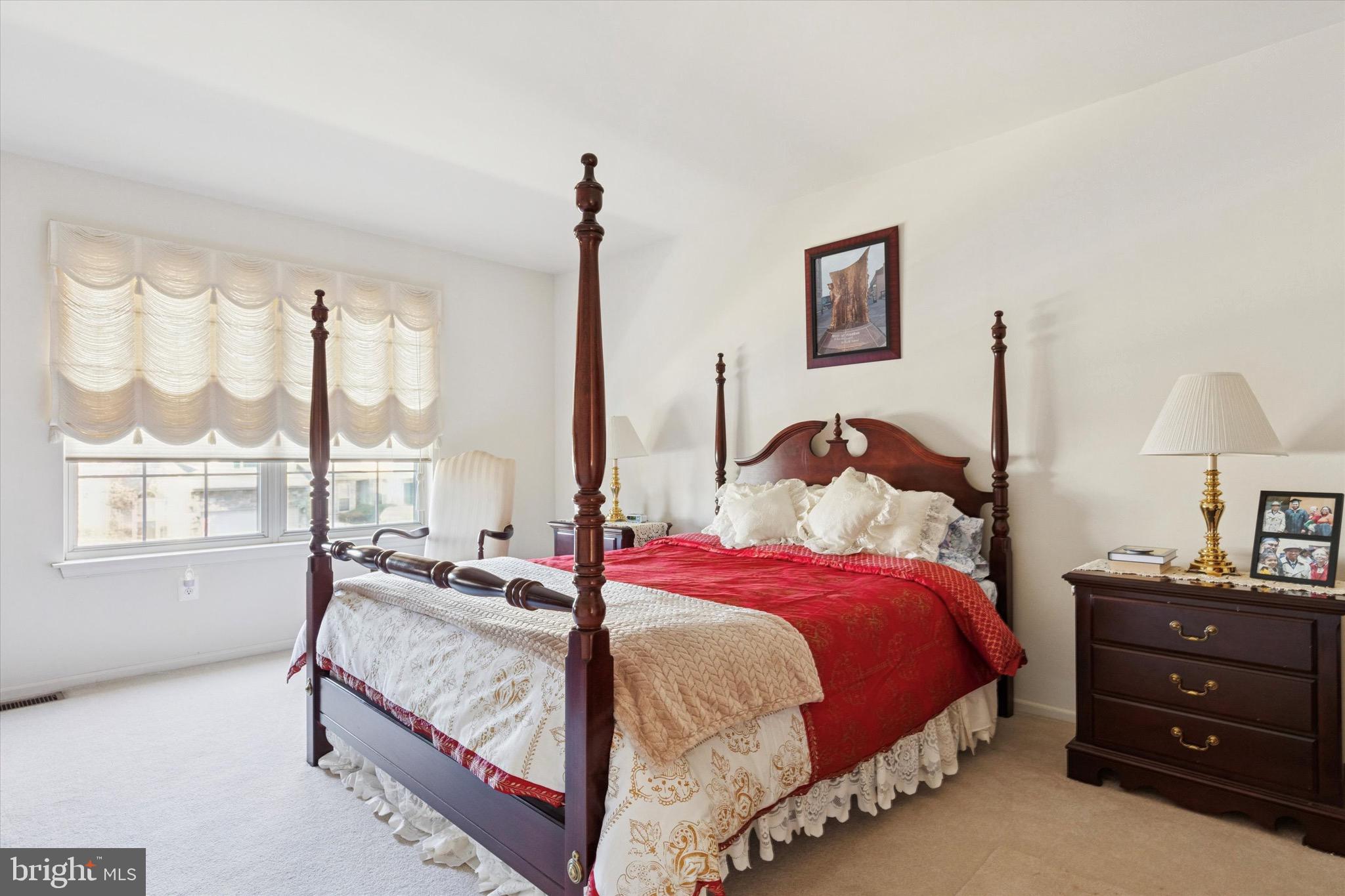 3821 Nanlyn Farm Circle Doylestown, PA 18902 - Photo 8 of 24 a bedroom with a bed a large window and a lamp