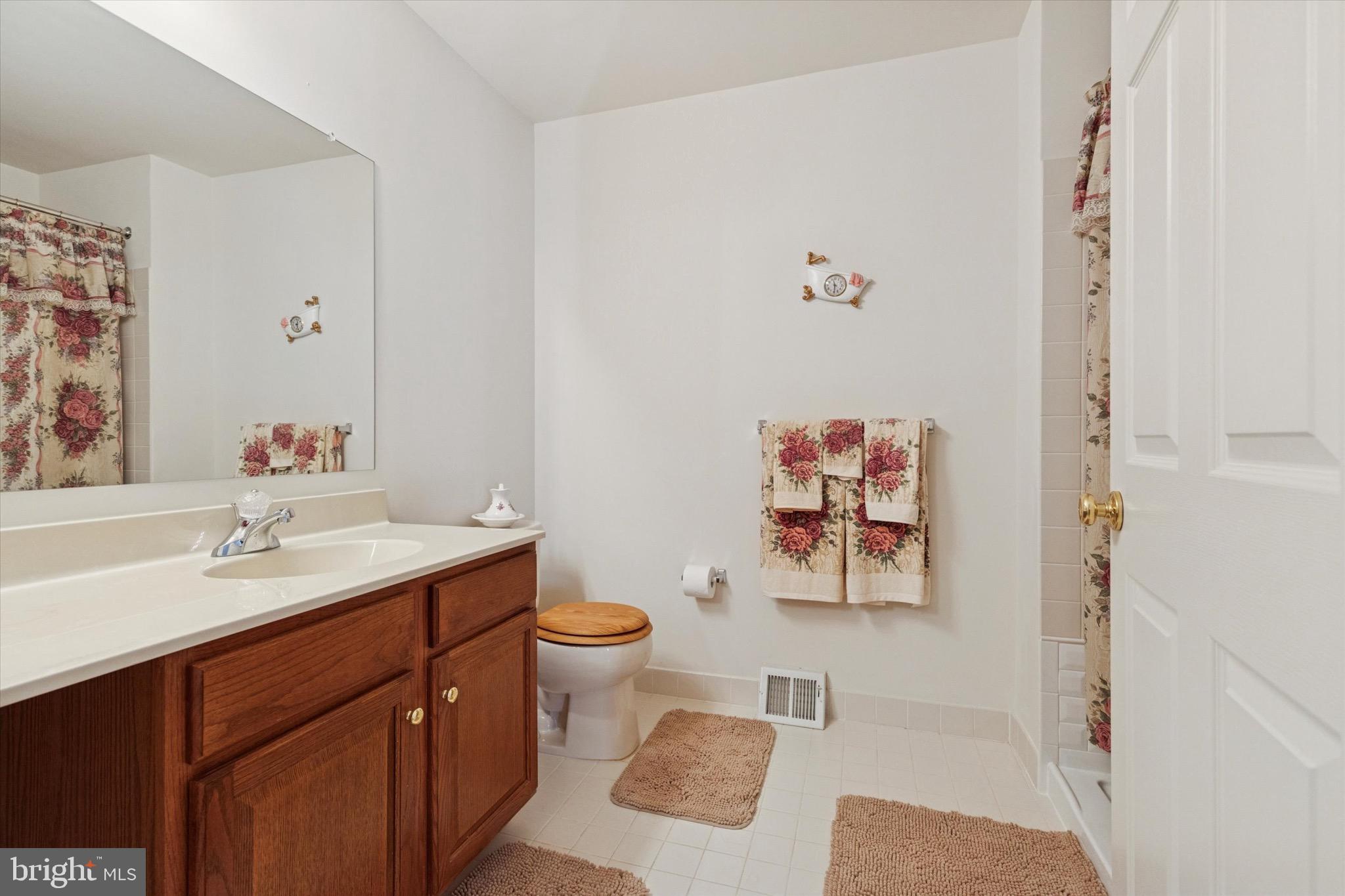 3821 Nanlyn Farm Circle Doylestown, PA 18902 - Photo 10 of 24 a bathroom with a sink mirror vanity and toilet