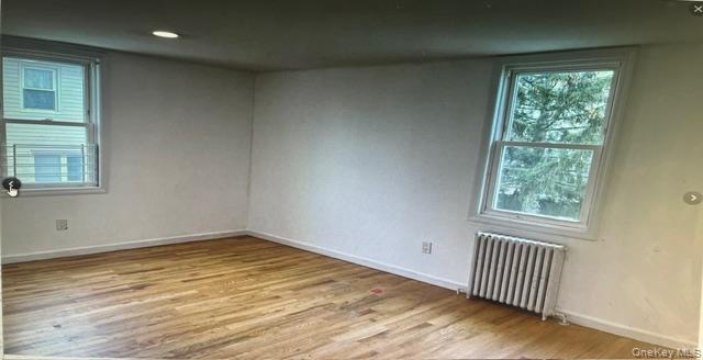 45 James Street Inwood, NY 11096 - Photo 9 of 11 an empty room with wooden floor and windows