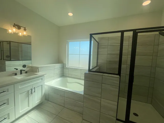 a bathroom with a bathtub and a sink