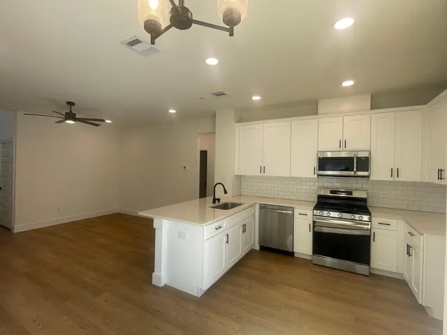 a kitchen with a sink stainless steel appliances and cabinets