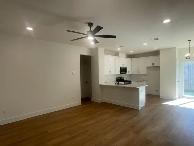 a kitchen with a refrigerator and a stove top oven