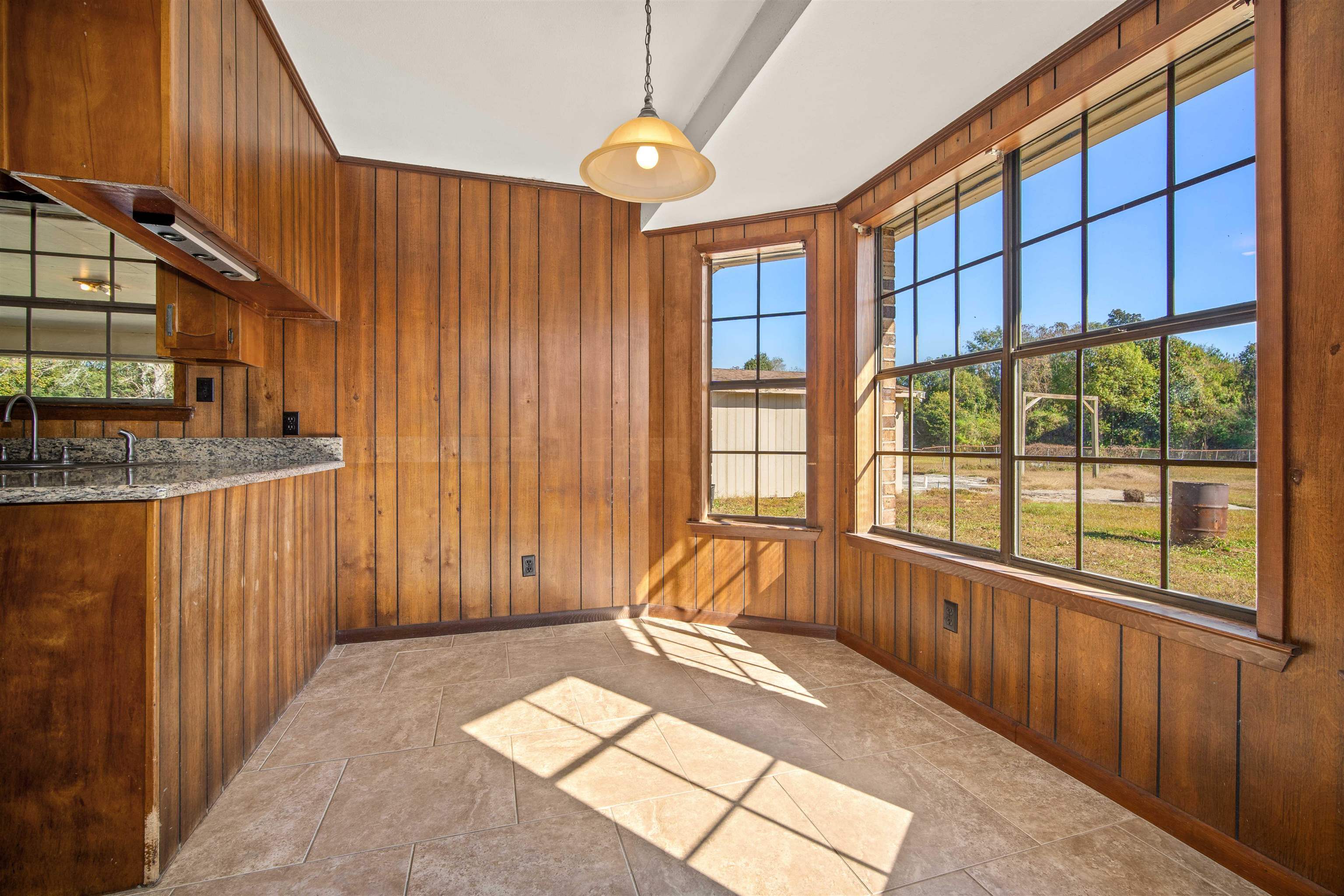 10285 Argyle Road Irvington, AL 36544 - Photo 8 of 28 Unfurnished dining area with wooden walls and light tile patterned floors