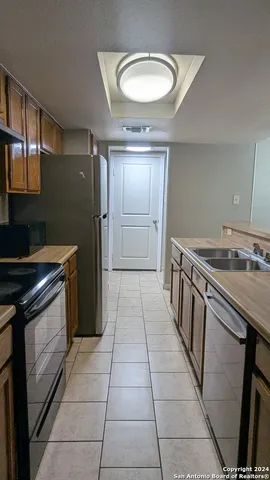 a kitchen with a stove top oven cabinets and a counter top space