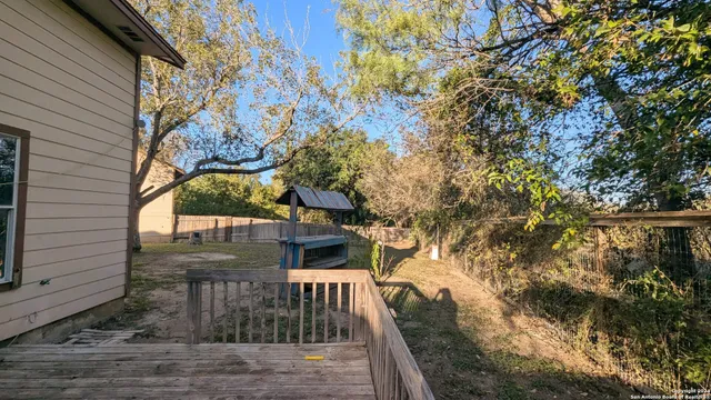 a view of a house with a tree in the background