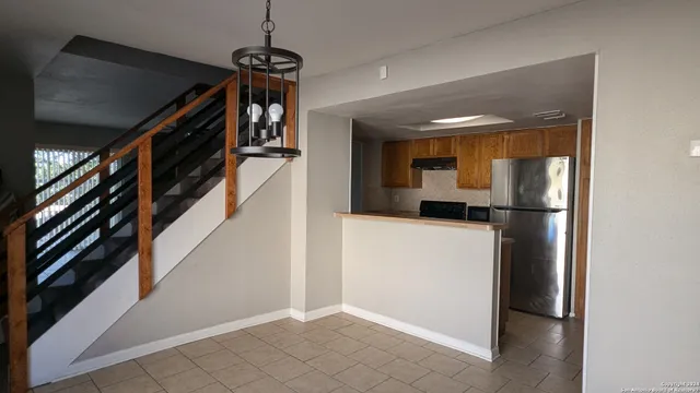 a hallway view with staircase