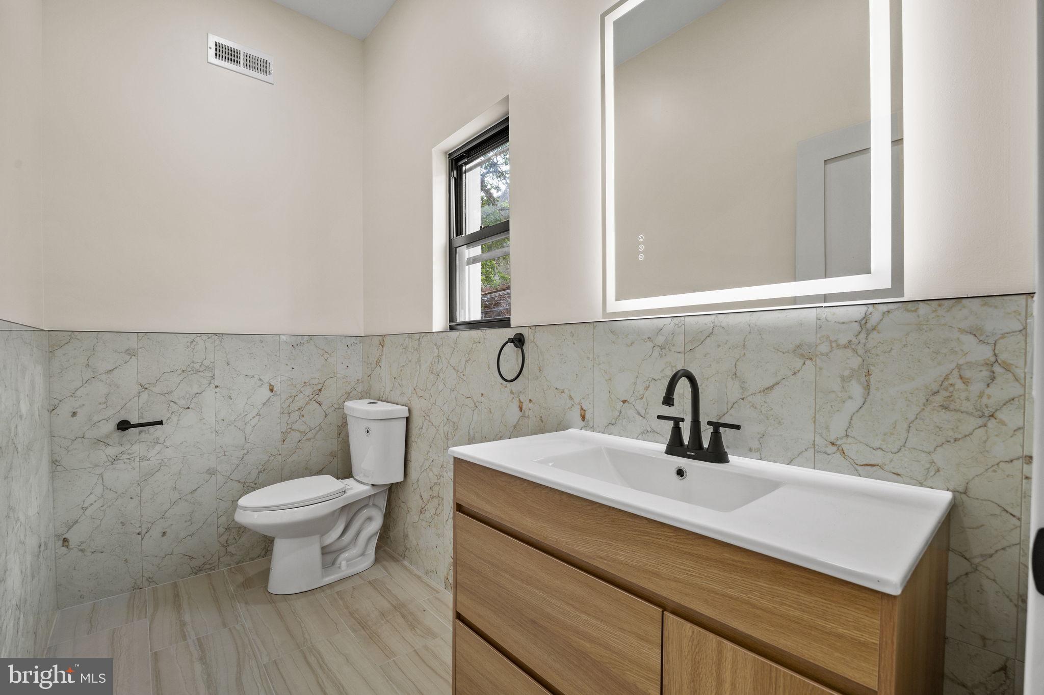 274 South Frazier Street Philadelphia, PA 19139 - Photo 11 of 34 a bathroom with a sink toilet and a mirror