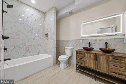 a bathroom with a toilet a sink and bathtub
