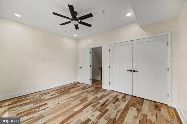 a view of a room with a ceiling fan
