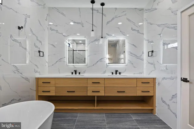 a white toilet sitting next to a bathroom sink and a shower