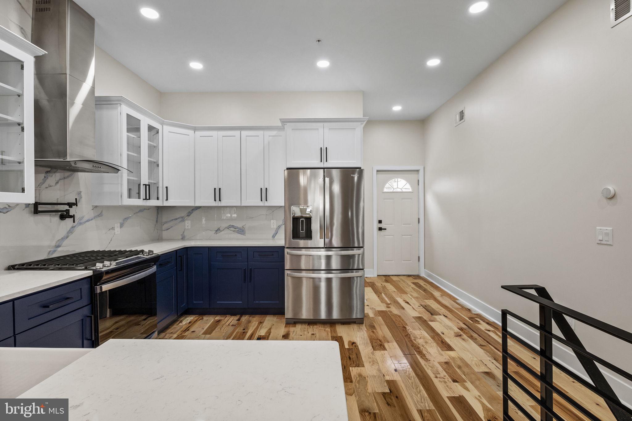 274 South Frazier Street Philadelphia, PA 19139 - Photo 8 of 34 a kitchen with kitchen island a sink stainless steel appliances and cabinets