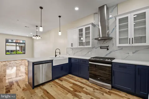 a kitchen with stainless steel appliances granite countertop a stove and cabinets