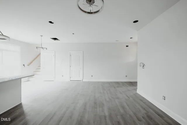 a view of room with window and wooden floor