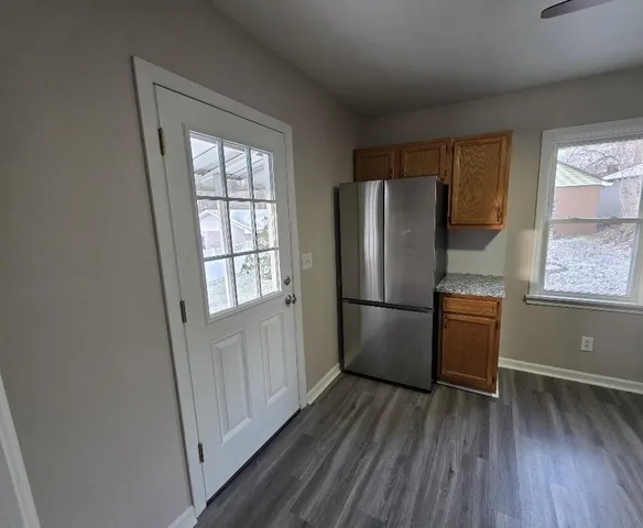 a kitchen with stainless steel appliances a refrigerator and a window