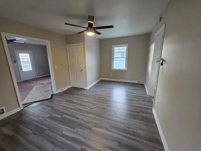 wooden floor in an empty room with a window