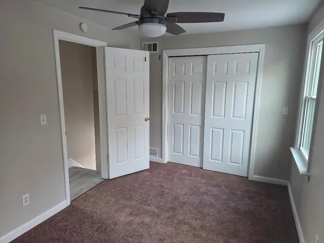 an empty room with windows and entryway