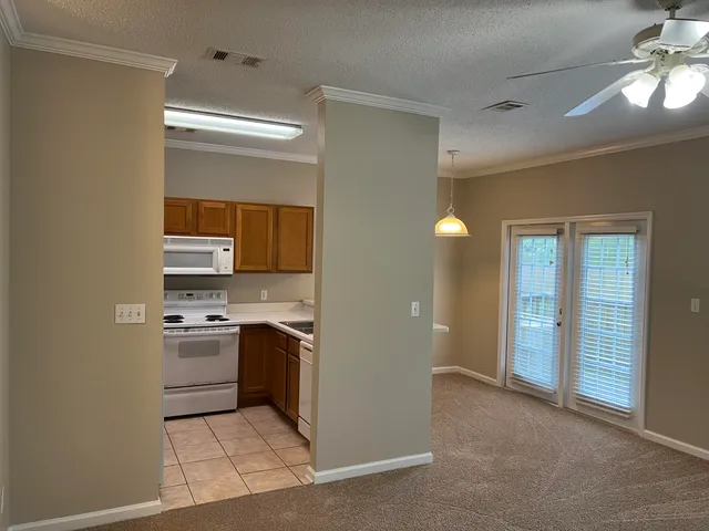 a kitchen with stainless steel appliances granite countertop a stove and a refrigerator