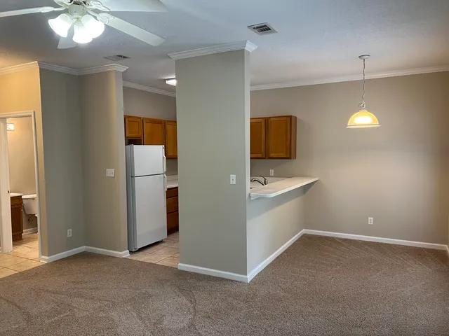 an empty room with a bathroom and a sink