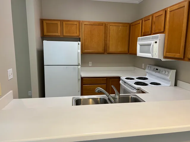 a kitchen with a white cabinets and white appliances