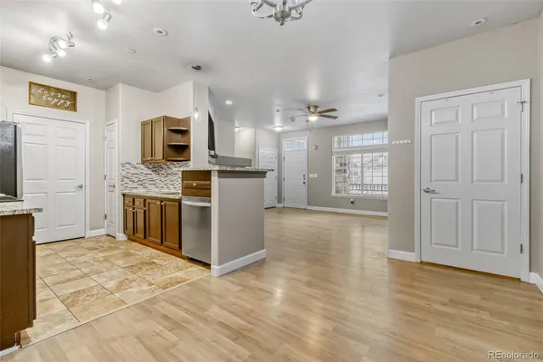 a kitchen with stainless steel appliances granite countertop a stove top oven a sink a counter space and cabinets