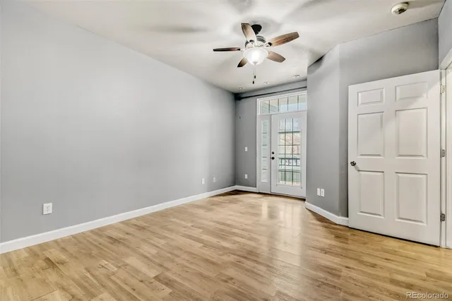 wooden floor in an empty room with a window