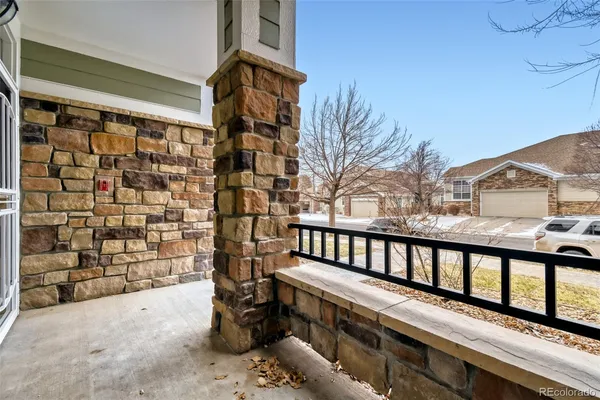 a view of a balcony with wooden fence and floor