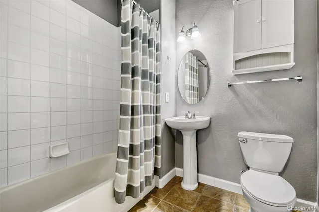 a bathroom with a toilet a sink and bathtub