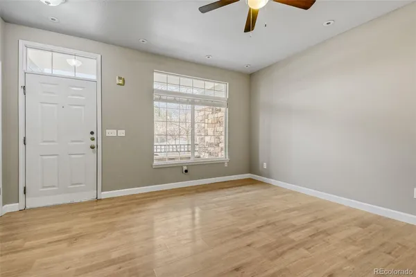 wooden floor in an empty room with a window