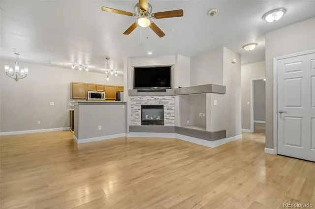 a view of a livingroom with a fireplace a sink and dishwasher kitchen view