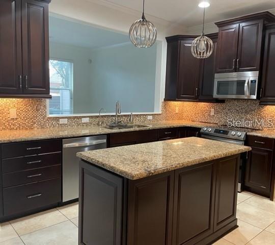 1032 Laurel Ridge Lane Sanford, FL 32773 - Photo 3 of 20 a kitchen with a sink a microwave a stove and refrigerator