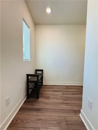 a view of a room with wooden floor and bench