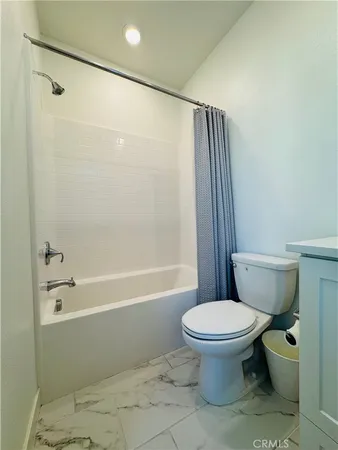 a large bed sitting in a bedroom next to a window
