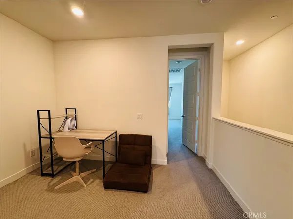 a view of workspace with wooden floor and lounge chair