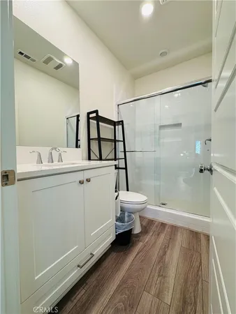 a bathroom with a sink a toilet and shower