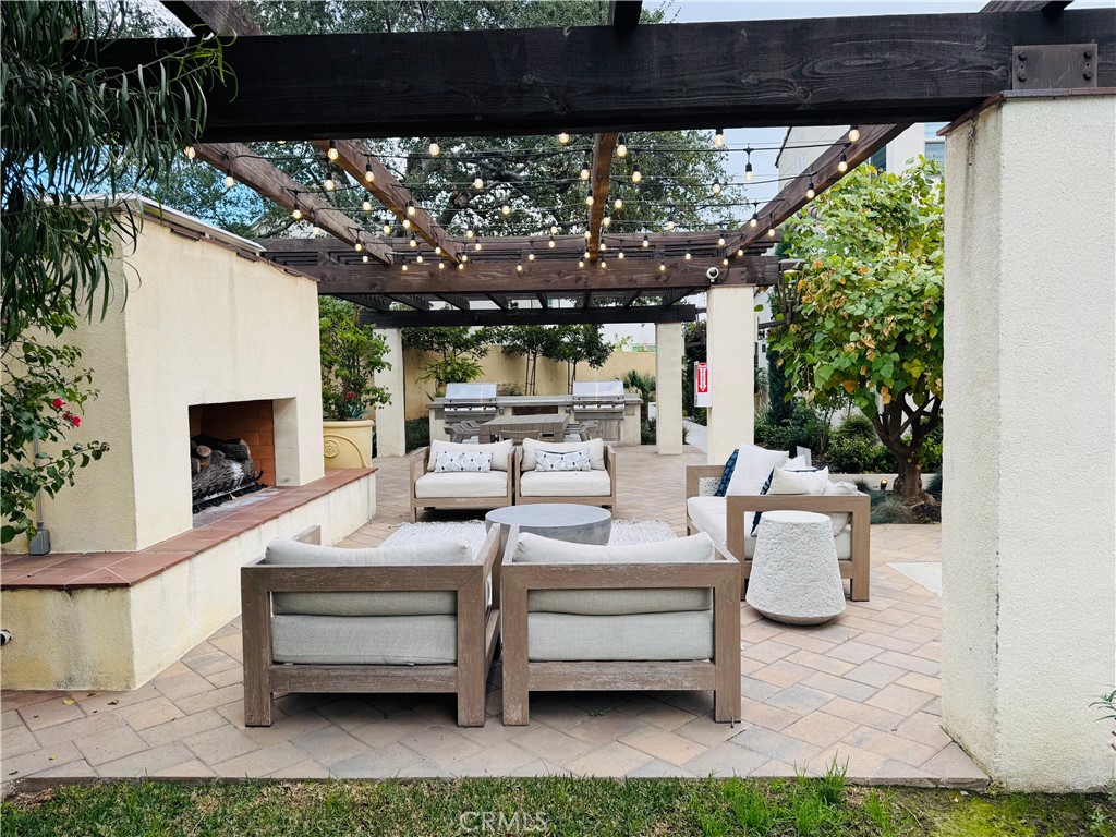 2626 Glamis Court Arcadia, CA 91007 - Photo 66 of 68 a view of a patio with couches table and chairs under an umbrella with a small yard