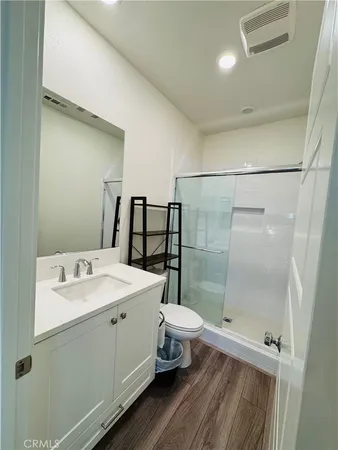 a kitchen with stainless steel appliances granite countertop a stove a microwave and a white cabinets