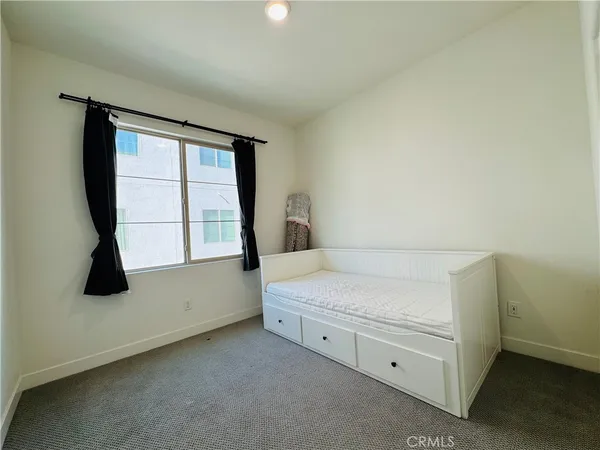 a close view of a refrigerator in kitchen and white cabinets