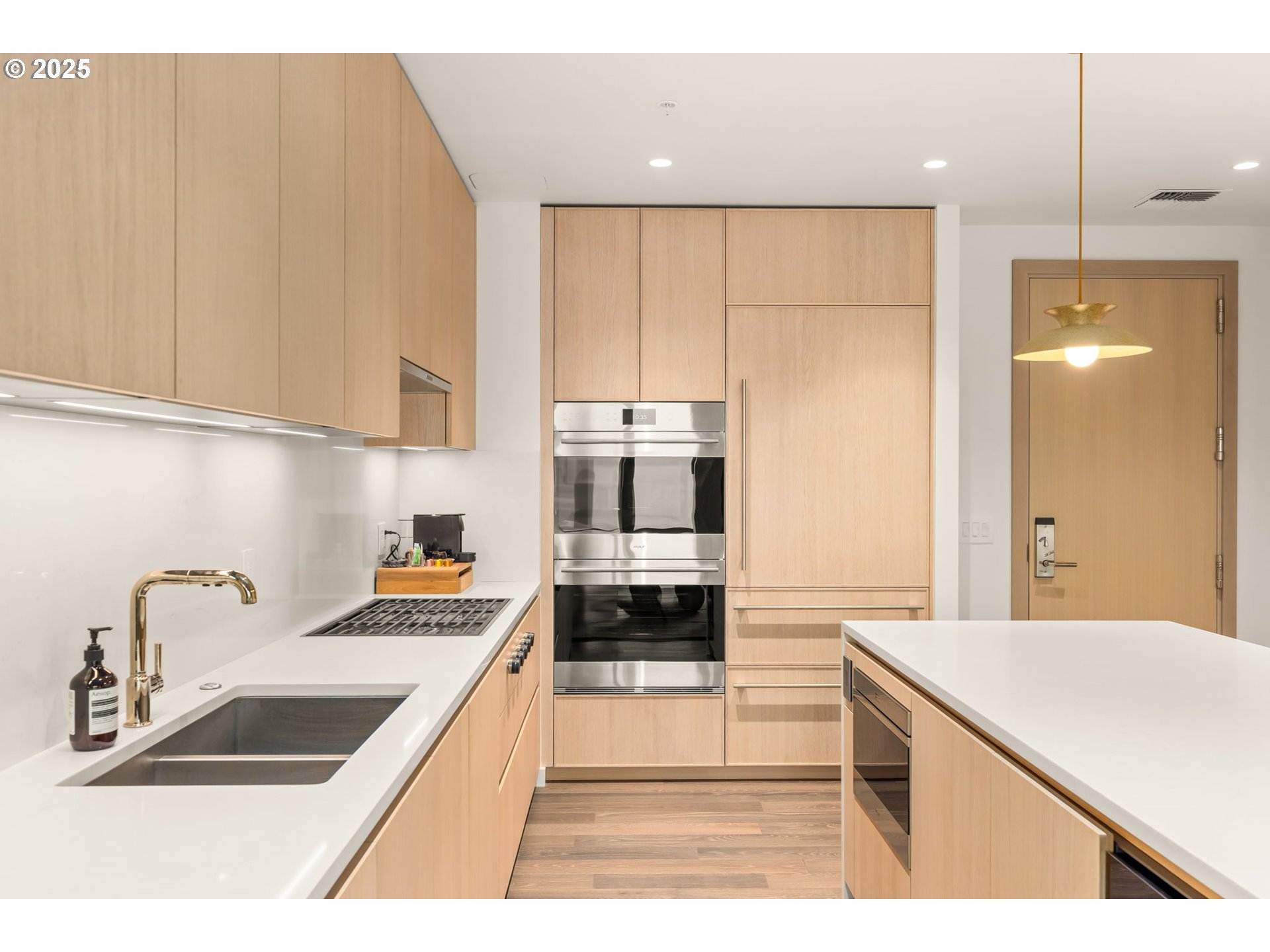 550 Southwest 10th Avenue, Unit 3003 Portland, OR 97205 - Photo 11 of 44 a kitchen with kitchen island a sink stainless steel appliances and cabinets