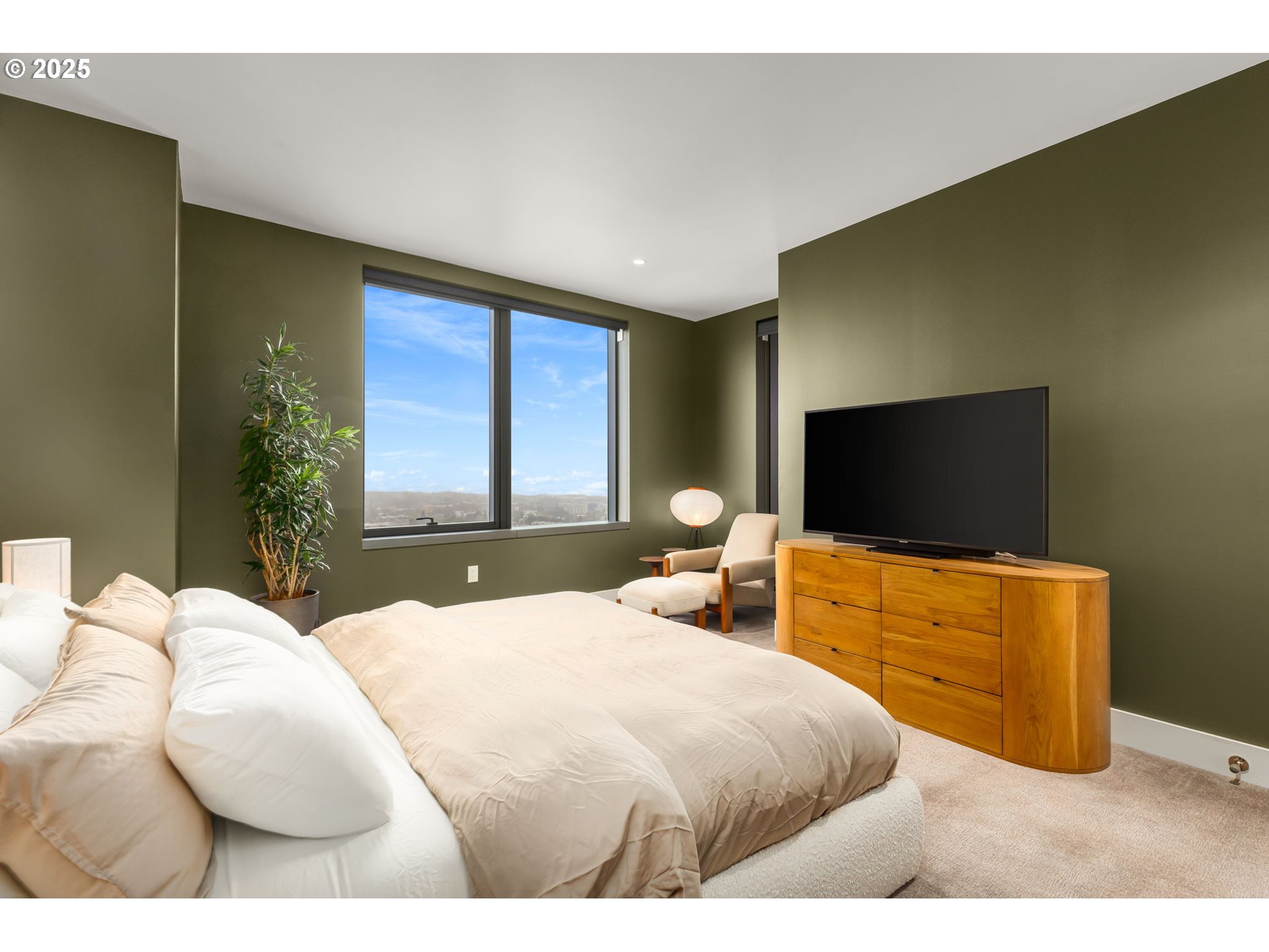 550 Southwest 10th Avenue, Unit 3003 Portland, OR 97205 - Photo 18 of 44 a bedroom with a bed and a flat screen tv