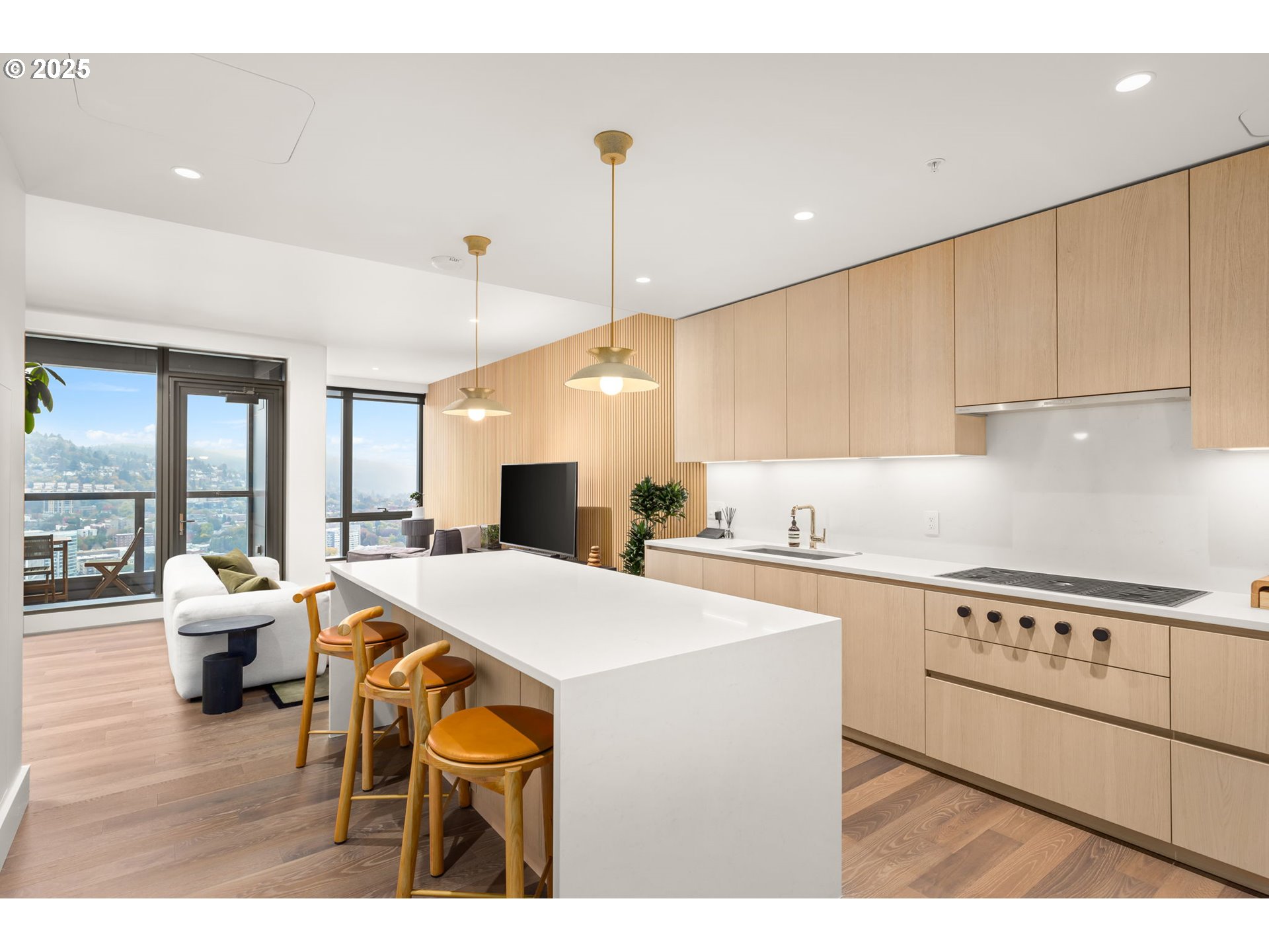 550 Southwest 10th Avenue, Unit 3003 Portland, OR 97205 - Photo 23 of 44 a kitchen with stainless steel appliances kitchen island granite countertop a stove a sink dishwasher and white cabinets with wooden floor