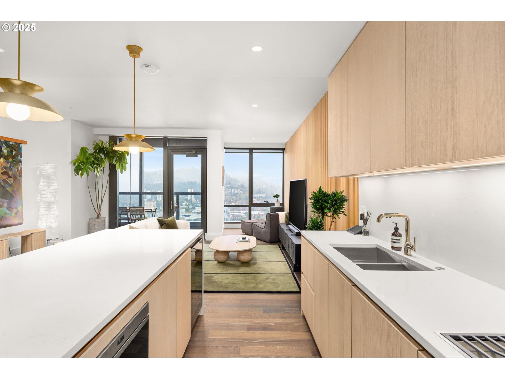 550 Southwest 10th Avenue, Unit 3003 Portland, OR 97205 - Photo 29 of 44 a large kitchen with kitchen island a sink a counter top space and living room view