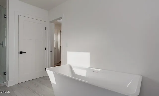 a view of walk in closet with empty racks