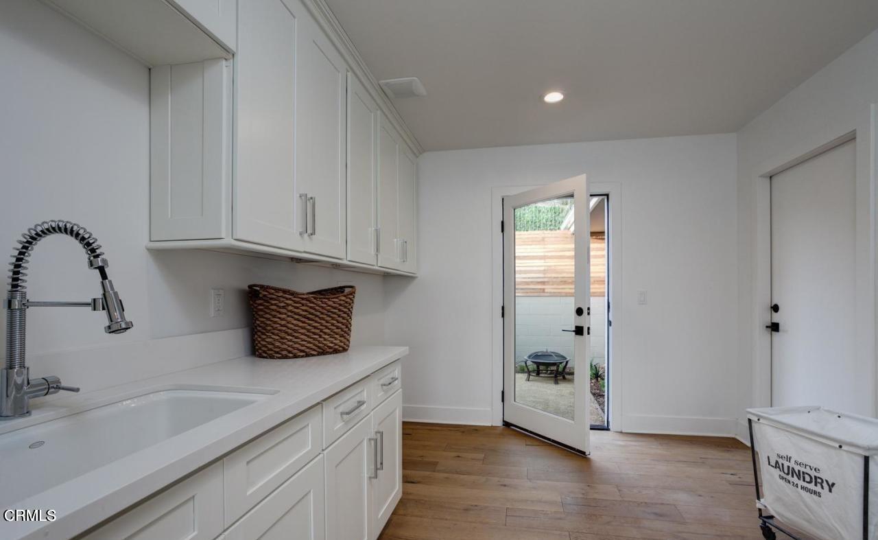 3026 Hilltop Drive Ventura, CA 93003 - Photo 14 of 31 a kitchen with granite countertop a sink and a stove top oven